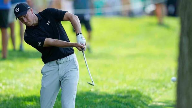Jordan Spieth hits from the rough during the first round of the Memorial Tournament.